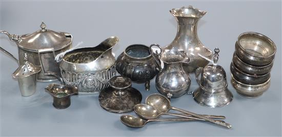 An early 19th century Dutch miniature silver bell, a similar baluster cream jug and embossed cream jug and sundry silver,